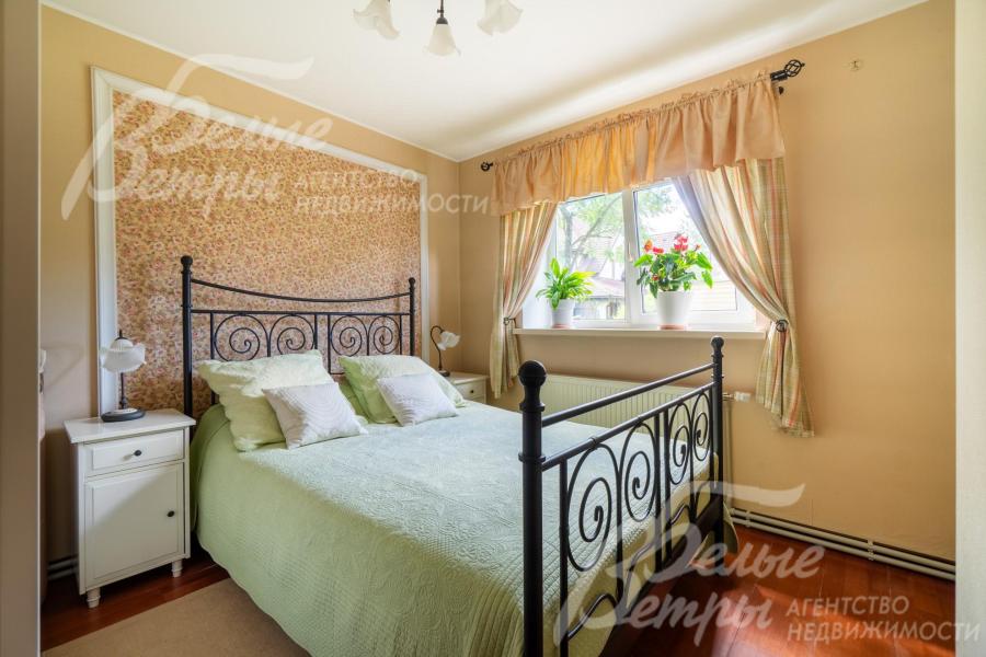 На первом этаже гостевого дома находится уютная спальня, обставленная мебелью