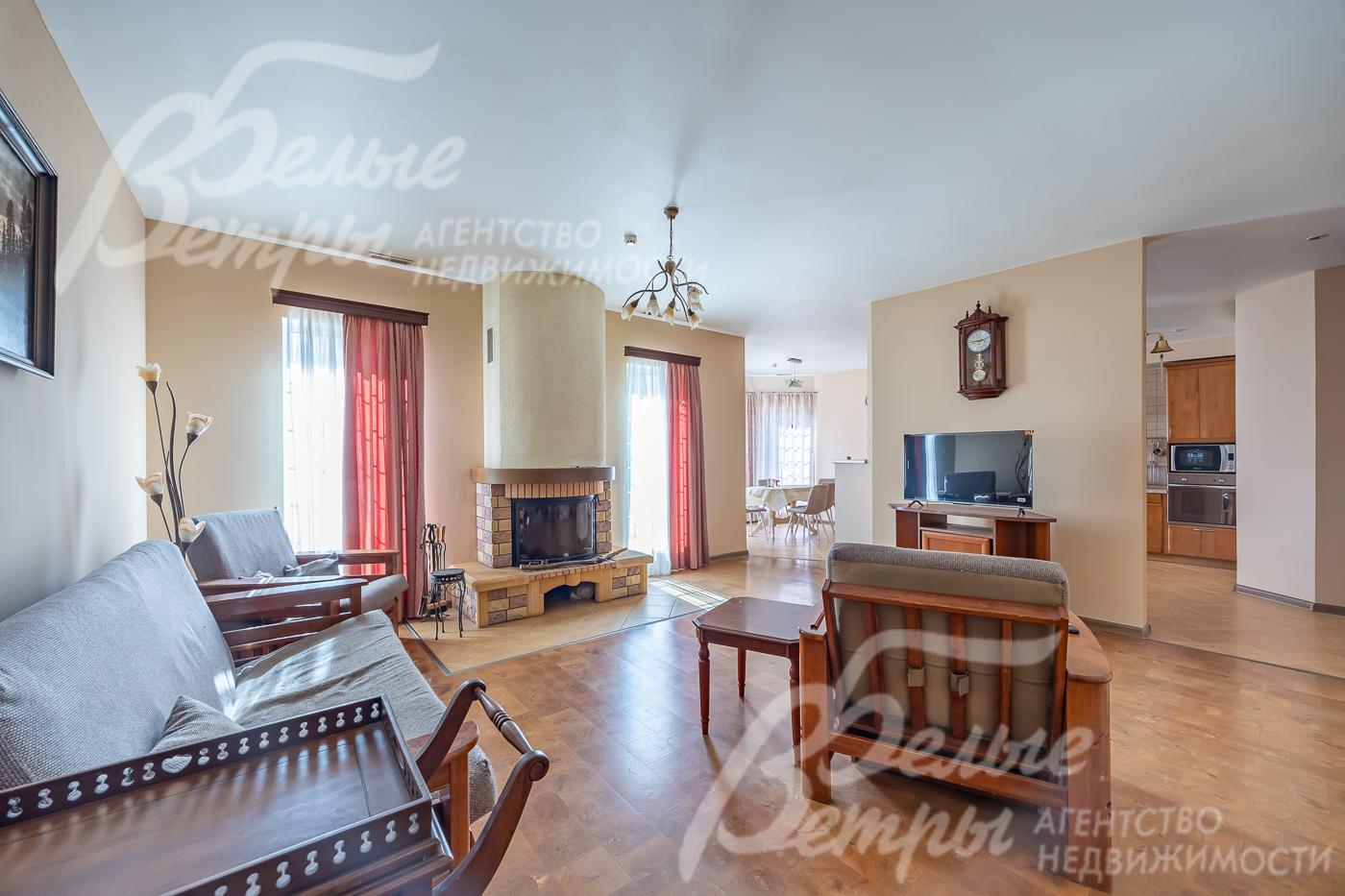 Гостиная с камином и панорамными окнами.