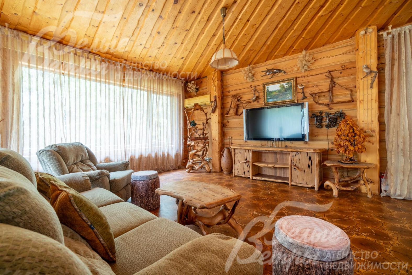 Природный интерьер дополняют пейзажная живопись, столики и тумбы из древесных ветвей, созданные мастерами вручную