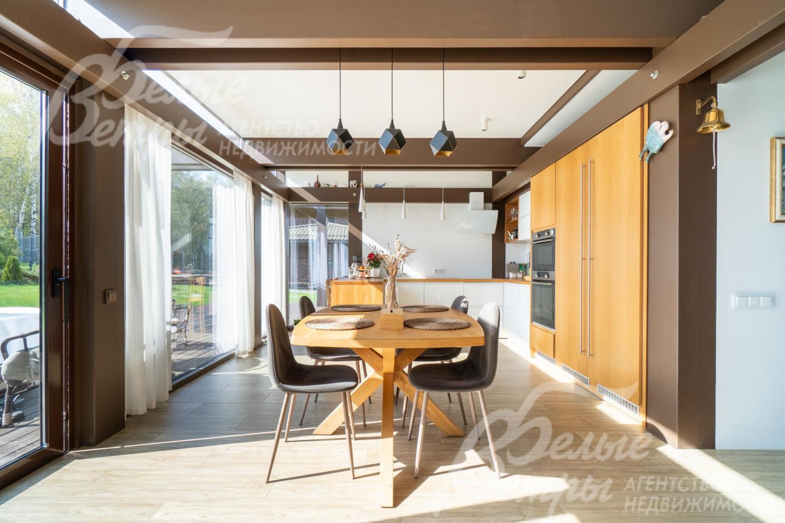 Кухня-столовая также максимально наполнена дневным светом, из неё открывается красивый вид на участок