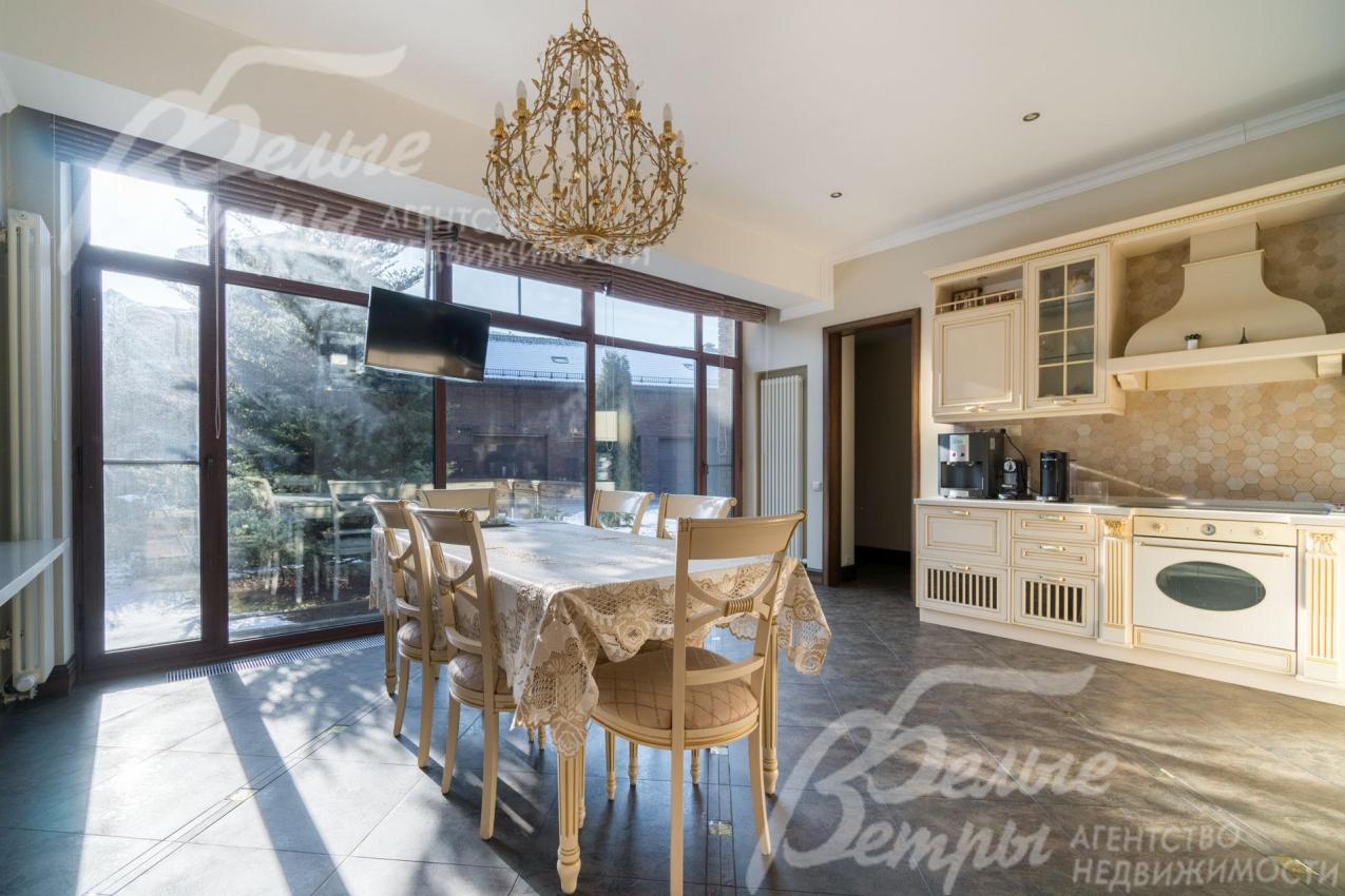 Светлая кухня с гарнитуром, встроенной техникой и обеденной группой на 6 персон