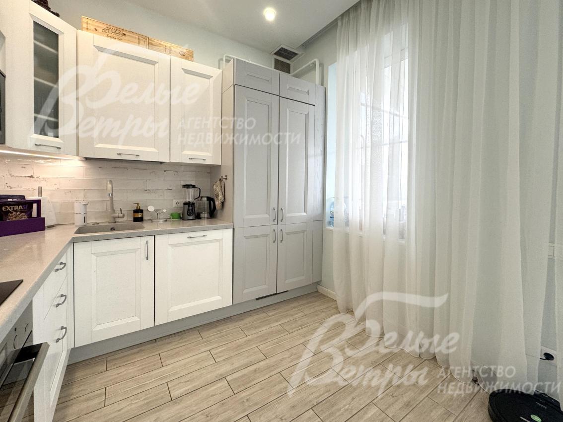 Выход из кухни на крытую террасу - через стеклянную дверь, декорированную лёгкими белыми шторами