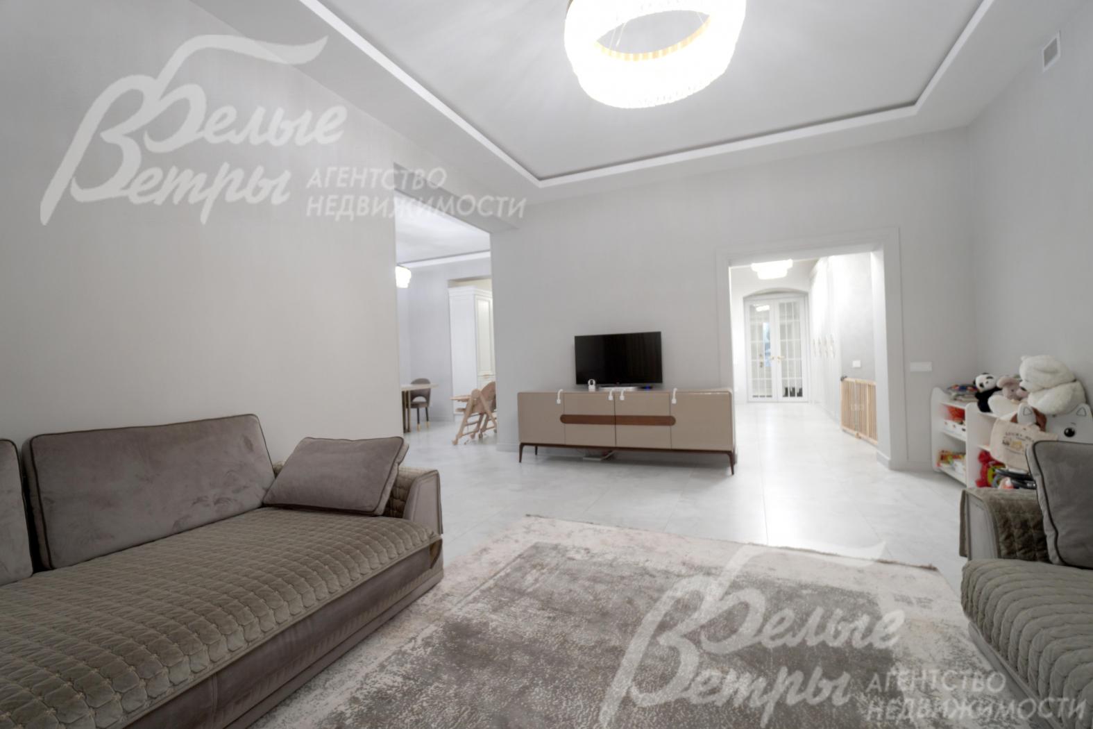 Зона гостиной. В доме - высокие потолки, стены окрашены декоративной штукатуркой с техникой шелкографии