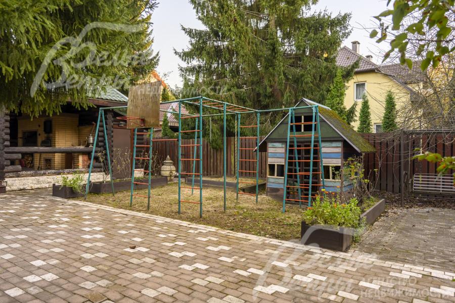 Рядом с беседкой - детский городок с турниками, качелями и домиком