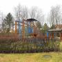Рядом с домом - детский городок с функциональными игровыми зонами на открытом воздухе среди зелёных насаждений